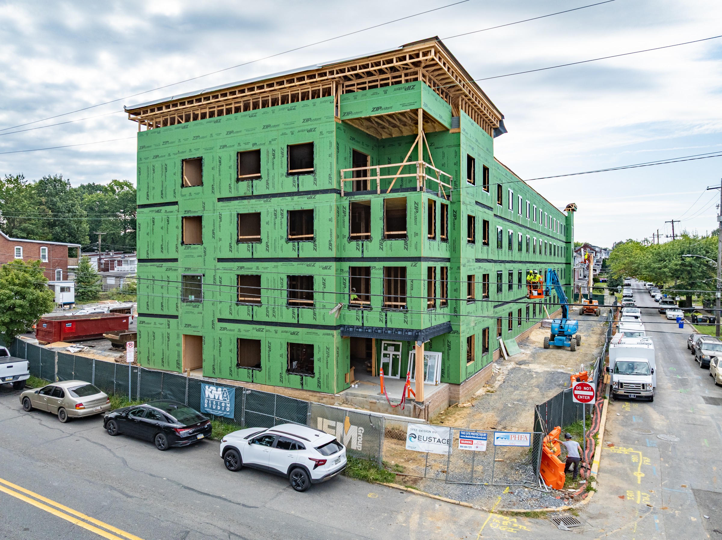 Street-facing corner of Woodward Lofts with exterior sheathing and open window bays